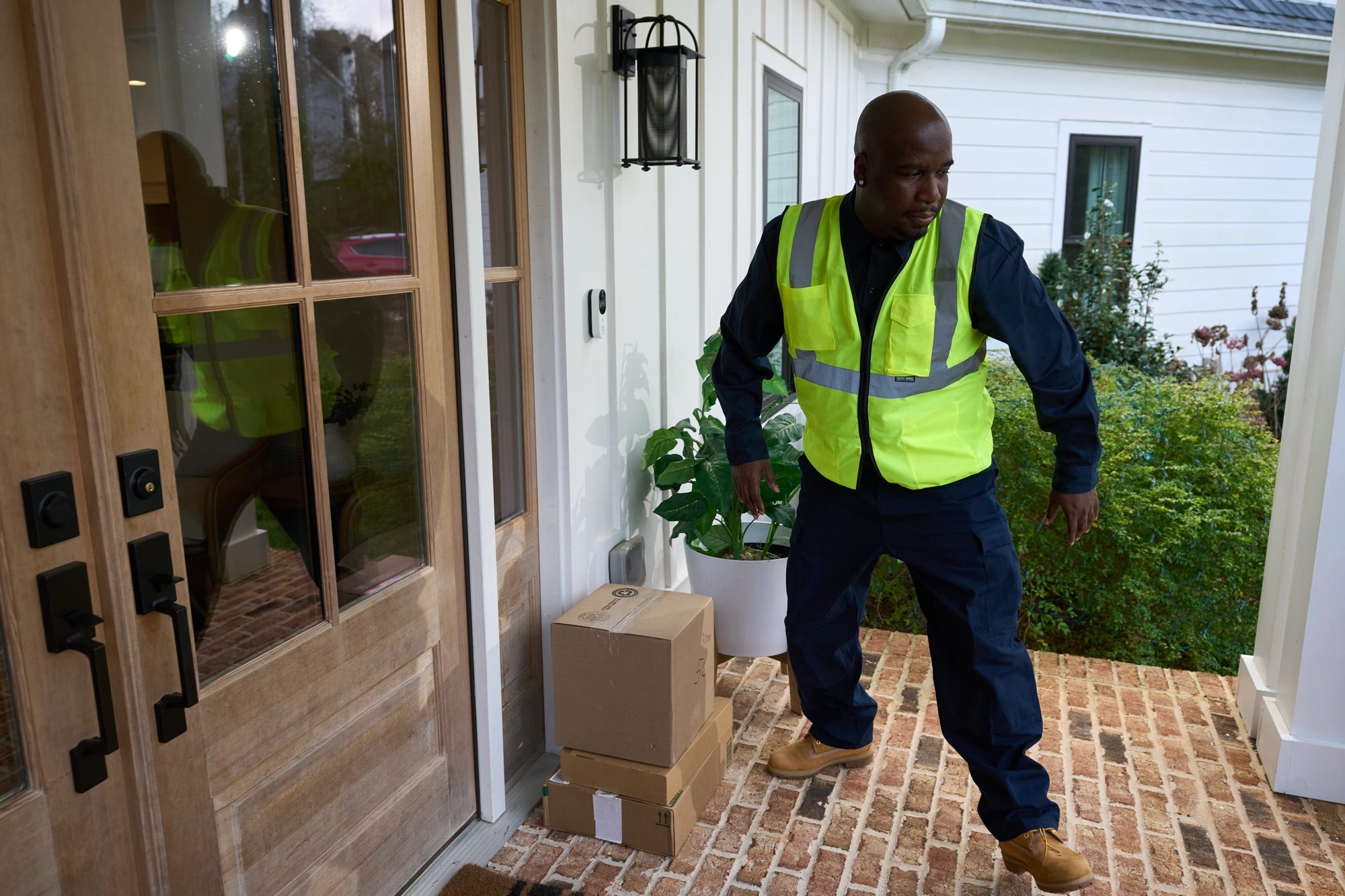 White Alarm.com ADC-VDB775 monitoring a package delivery