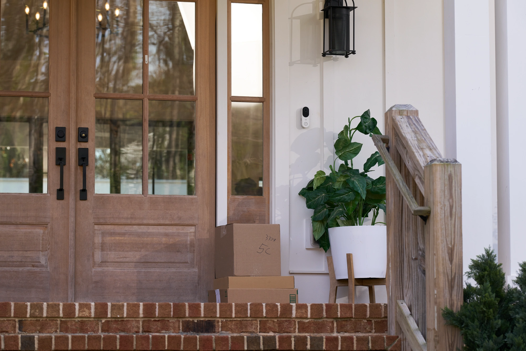 White Alarm.com ADC-VDB775 installed beside a residential front door