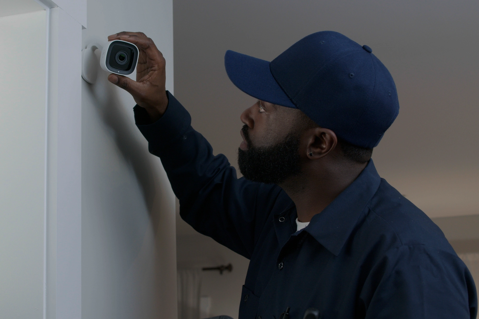 ADC-V516 Wall Installation Professional installing an Alarm.com ADC-V516 indoor camera on a wall