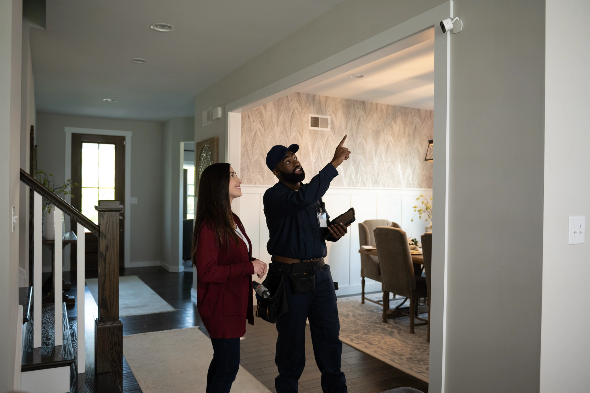 ADC-V516 Ceiling Installation Consultation Homeowner reviewing an Alarm.com ADC-V516 ceiling installation