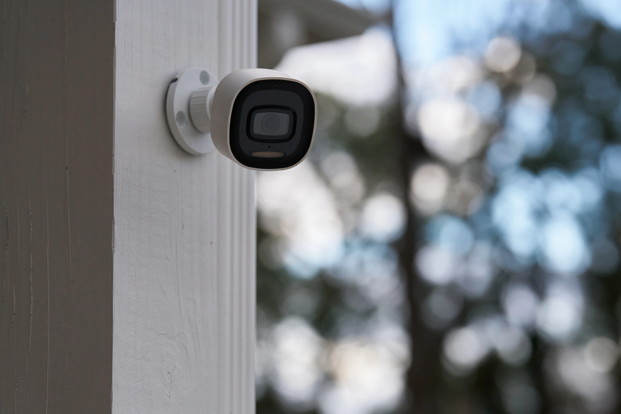 Alarm.com ADC-V730 outdoor spotlight camera installed on an exterior wall