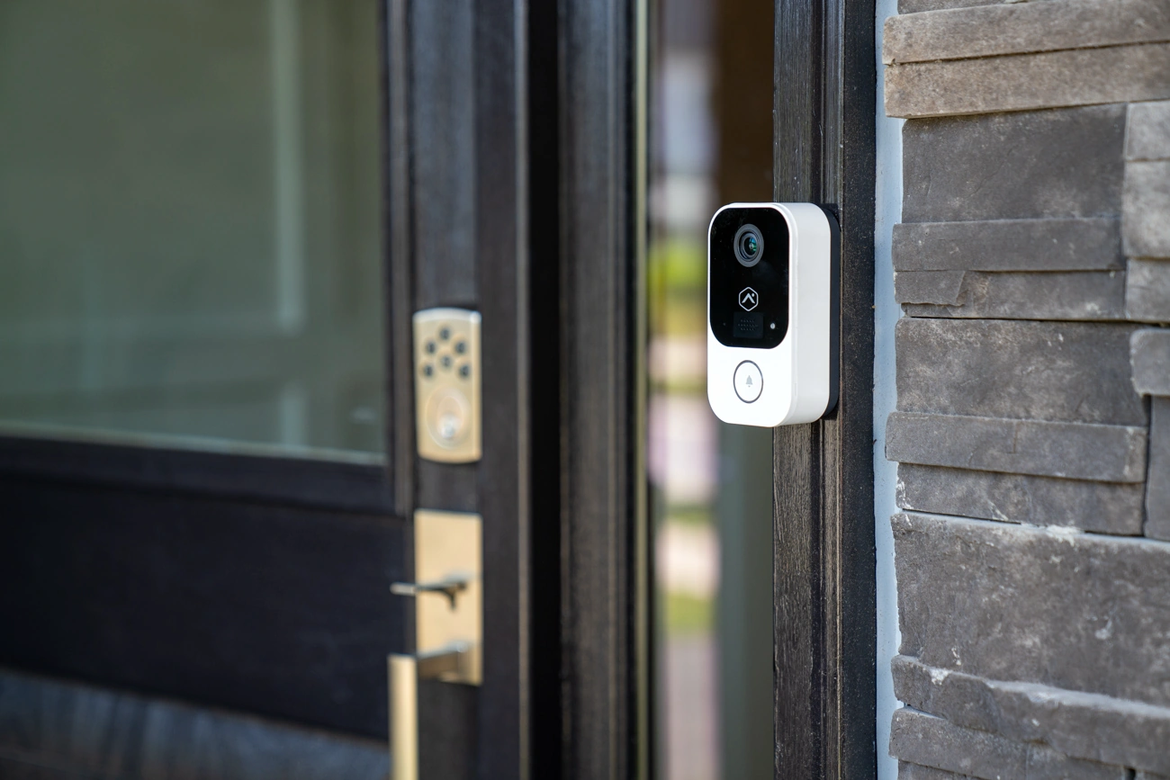 Alarm.com ADC-VDB755P PoE door station installed beside an entry door