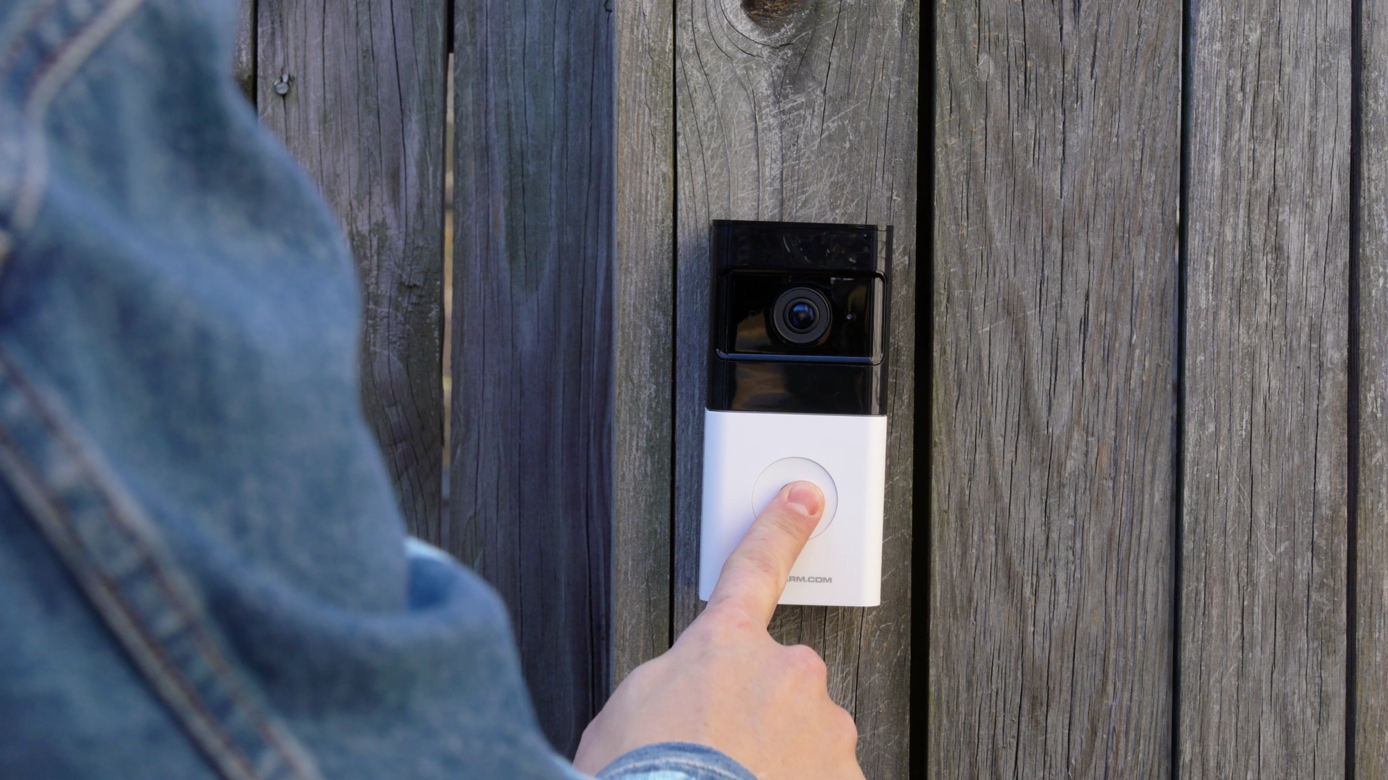 Visitor pressing an installed Alarm.com ADC-VDB780B video doorbell