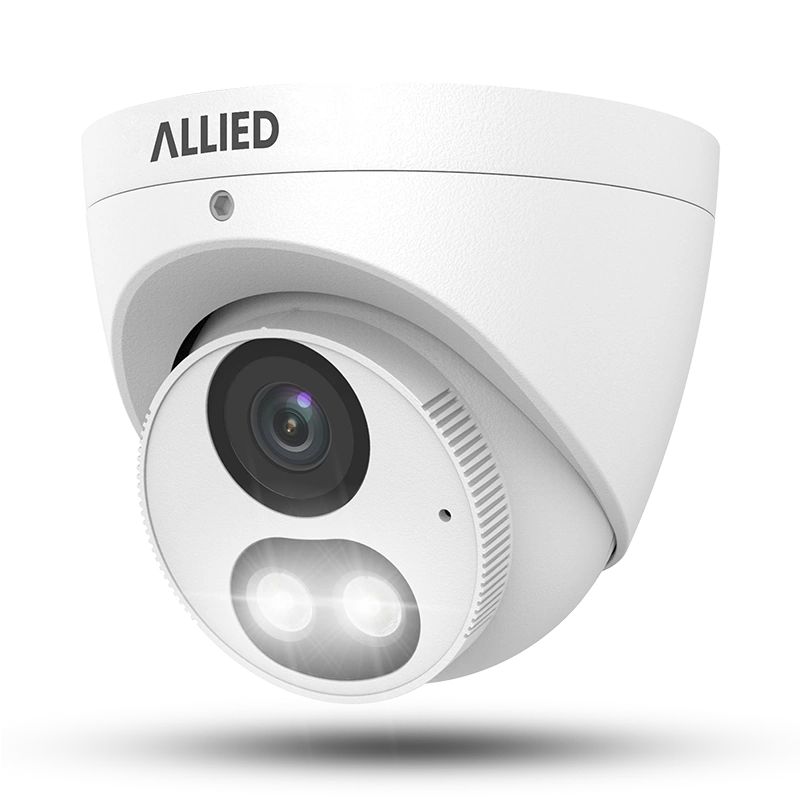Allied dual-light IP turret camera front-left view with warm lights illuminated