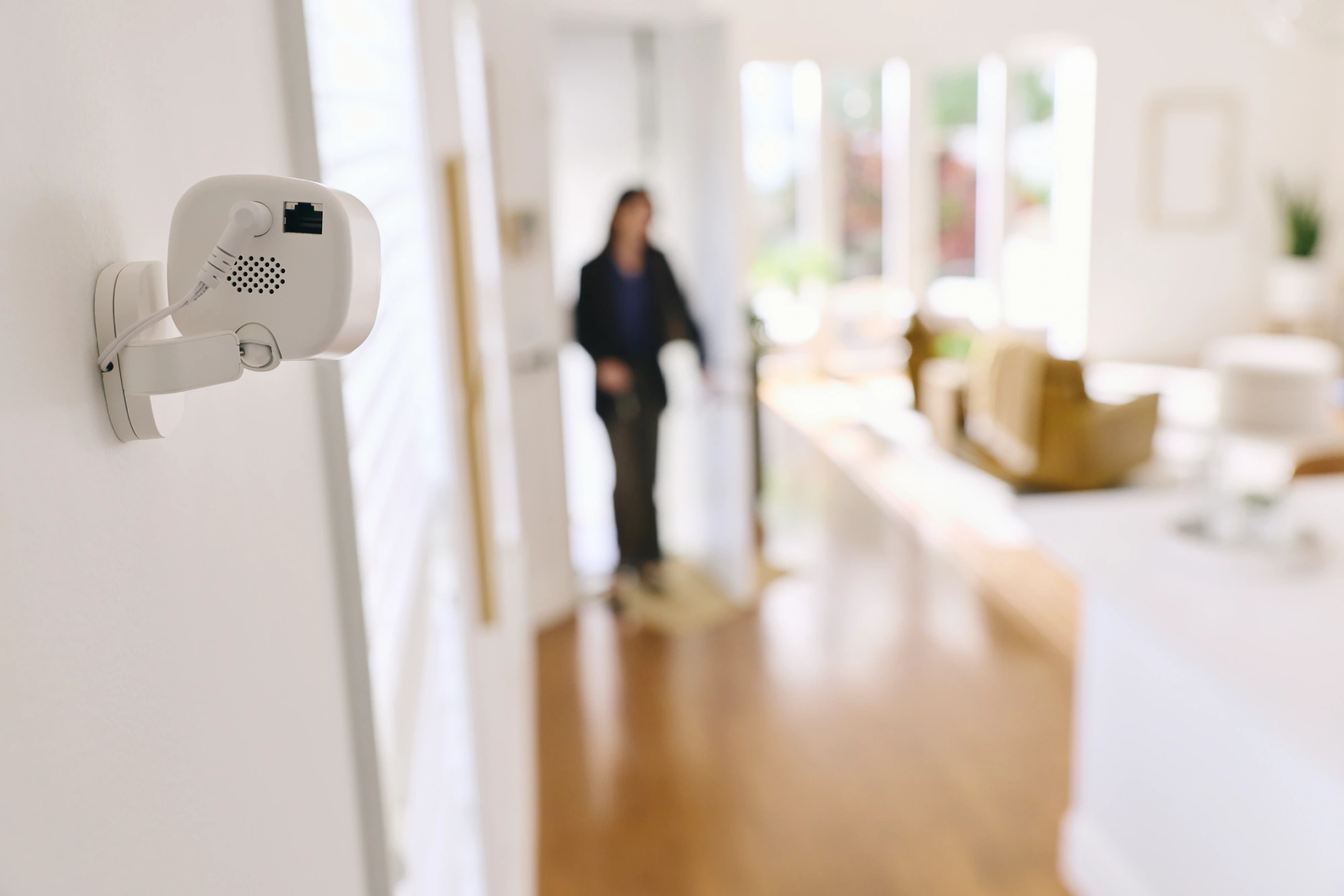 Wall-mounted Alarm.com ADC-V530 monitoring an indoor doorway