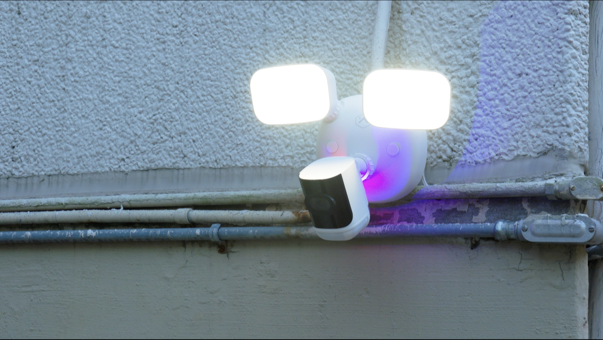 Alarm.com V729 floodlights and warning lights activated on an exterior wall